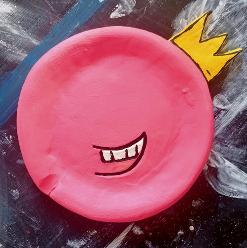 pink trinket holder with a yellow crown on the side.