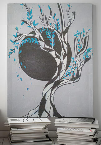 Black and white tree with blue leaves and a grey background with a black moon in the center.